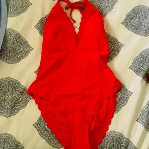 One piece, burnt red, new with tags and size 12.
